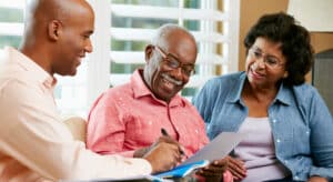 Fundraising professional talking with older couple about planned giving