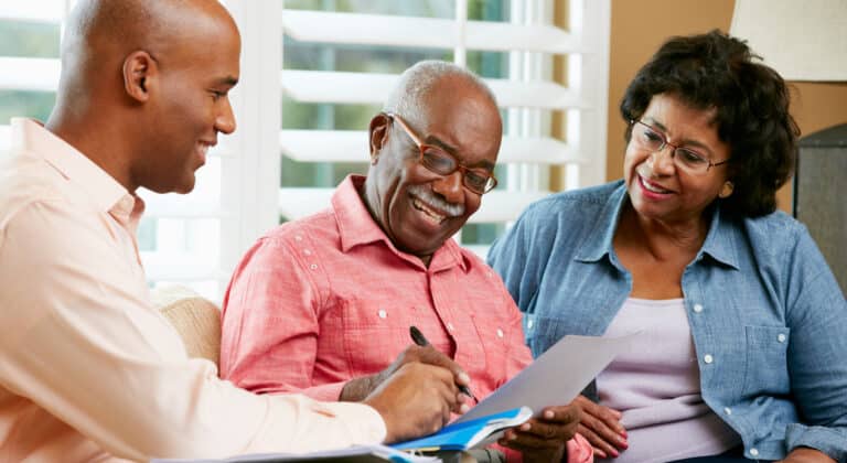 Fundraising professional talking with older couple about planned giving